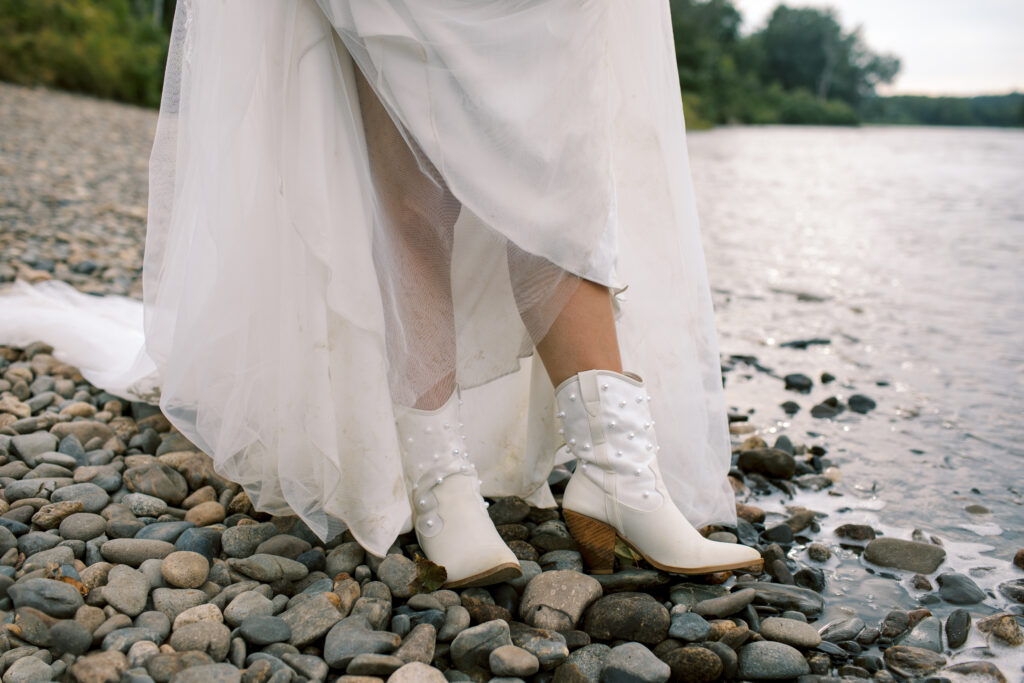 Bride wearing pearl cowboy boots with wedding dress