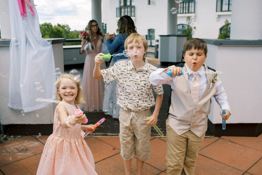 Kids at the Algonquin Resort blowing bubbles after wedding ceremony 